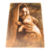 A print featuring an artistic depiction of Jesus in a white robe holding a lamb.