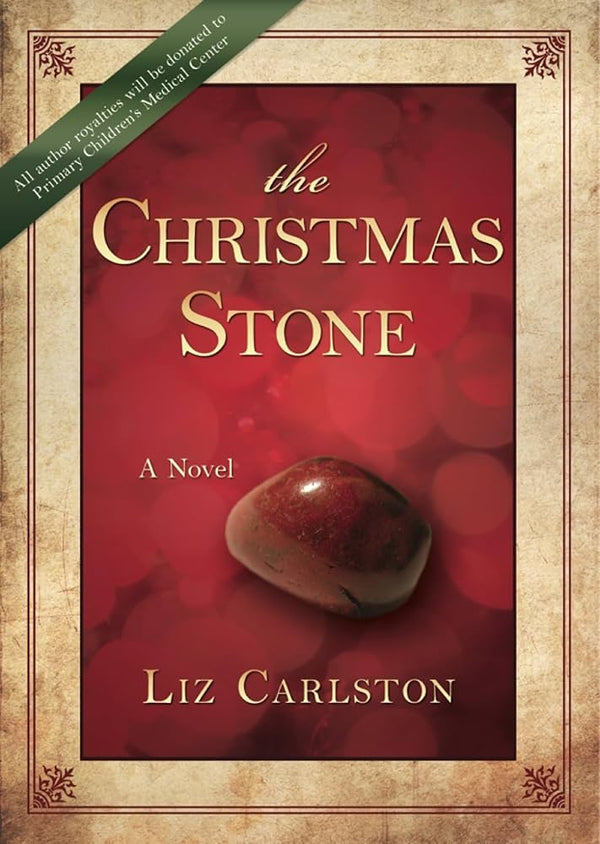 Book cover of 'The Christmas Stone' by Liz Carlston with a red background and stone illustration.